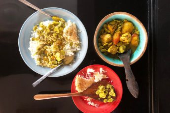 Plate of Persian fava bean rice next to a bowl of fava bean & apricots Persian stew khoresh next to a plate of tadig crunchy rice