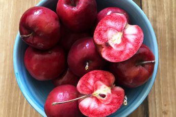 blood apple red inside & out in a blue bowl | food styled for Persian food blog